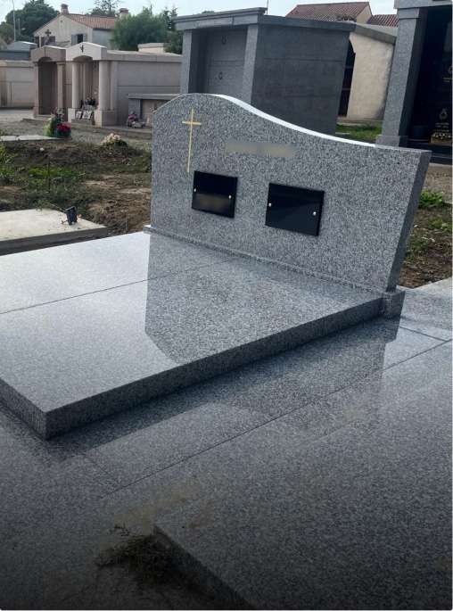 Tombe en granit avec croix dorée