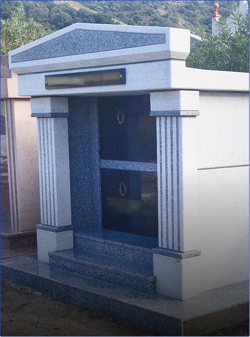 Tombe en pierre avec colonnes décoratives.